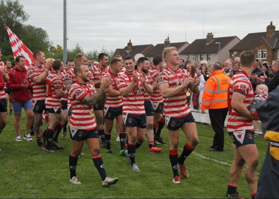 Rugby league players walking onto the pitch
